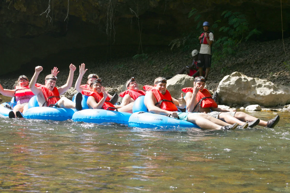 Group of cruise guests cave tubing in Belize
